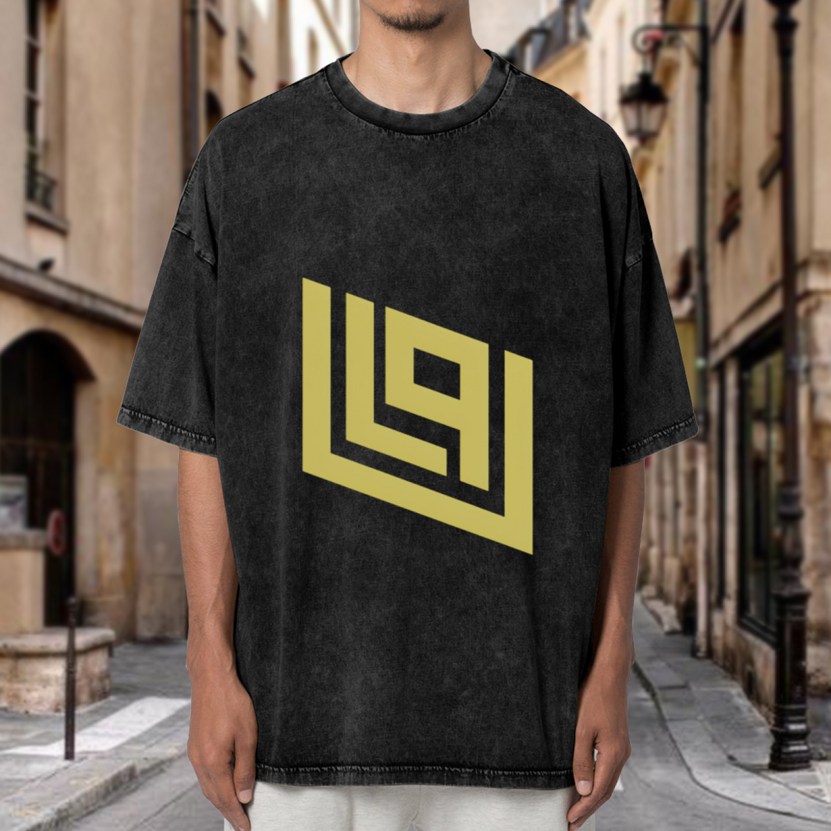 Product image of a washed graphic T-shirt featuring gold angular geometric emblem
