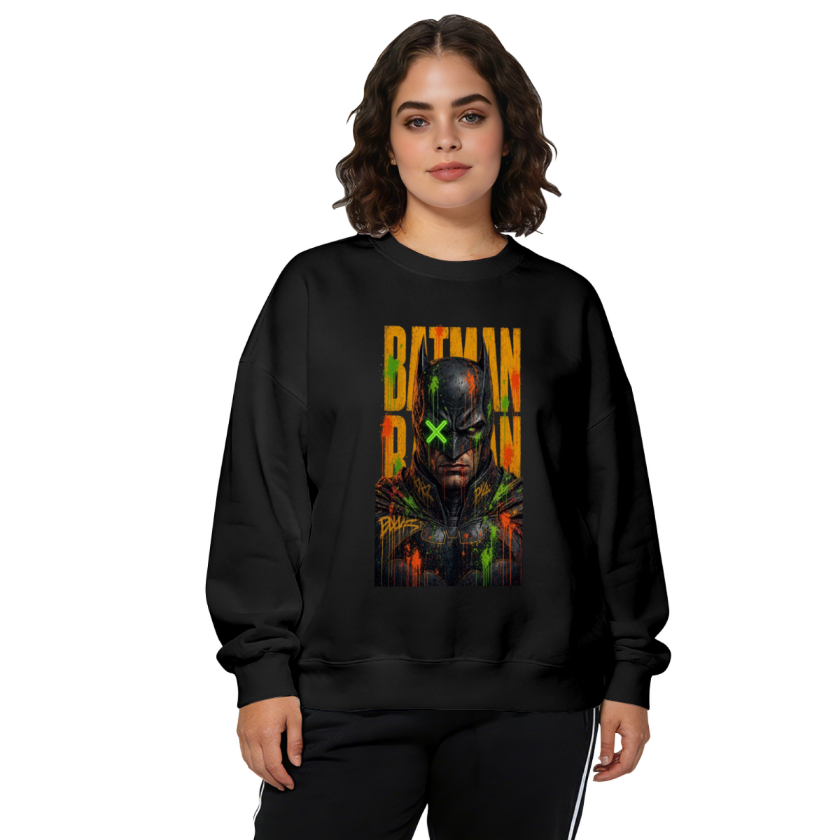 Front-facing model wearing a women's crewneck sweatshirt decorated with a tall graffiti-style cowl portrait with a green X across the eyes