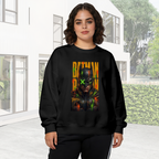 Outdoor photograph of a model in a women's crewneck sweatshirt bearing a tall graffiti-style cowl portrait with a green X across the eyes