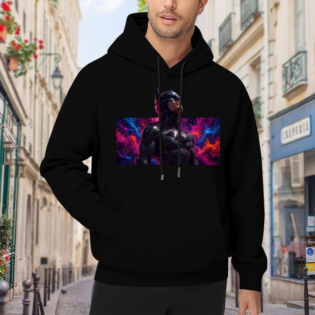 On-location model photograph displaying an armored cowl portrait surrounded by electric pink and blue light on the front of a men's hoodie