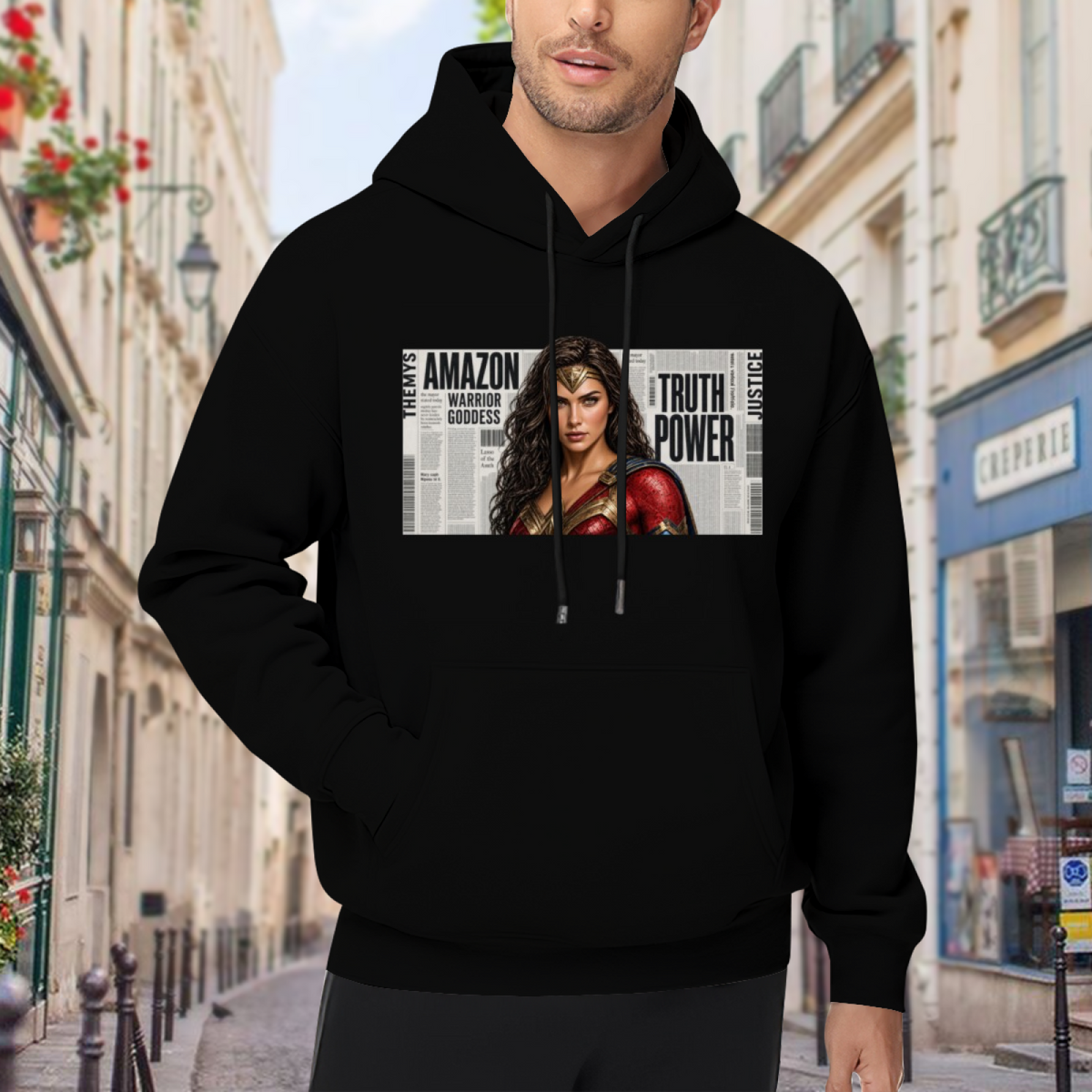 On-location model photograph displaying a determined warrior portrait over large newspaper-style lettering on the front of a men's hoodie