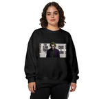 Front-facing model wearing a women's crewneck sweatshirt decorated with a suited clown portrait against a newspaper-style text collage