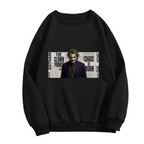 A suited clown portrait against a newspaper-style text collage shown on the front of a women's crewneck sweatshirt in a standalone product shot