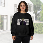 Outdoor photograph of a model in a women's crewneck sweatshirt bearing a suited clown portrait against a newspaper-style text collage