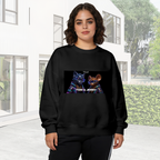 On-location model photograph displaying a cartoon cat and mouse against a neon-toned backdrop on the front of a women's crewneck sweatshirt