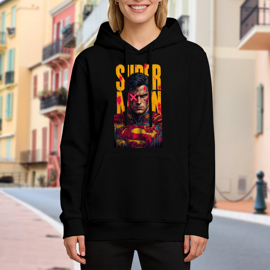 On-location model photograph displaying a tall caped graffiti portrait with a pink X across the eyes on the front of a women's hoodie
