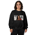 Women's crewneck sweatshirt seen on a model, its front graphic depicting a determined warrior portrait over large newspaper-style lettering