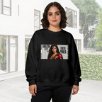 A determined warrior portrait over large newspaper-style lettering visible on a women's crewneck sweatshirt in an outdoor front model view