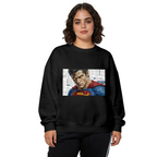 Women's crewneck sweatshirt seen on a model, its front graphic depicting a tightly cropped intense face above a cape against newsprint