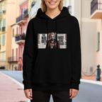 Women's hoodie worn outside, with the camera facing the graphic of a pigtail portrait layered over rectangular newspaper-style lettering