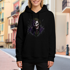 On-location model photograph displaying a grinning clown portrait framed by rough dark strokes on the front of a women's hoodie
