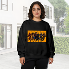 On-location model photograph displaying a group of costumed figures charging across a warm-toned action panel on the front of a women's crewneck sweatshirt