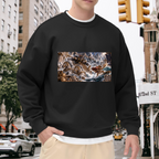 Outdoor photograph of a model in a men's crewneck sweatshirt bearing a trident-bearing cat surrounded by surging waves in a sea battle