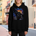 Lifestyle image outdoors: women's hoodie with a front graphic of a winged masked figure leaping amid electric bolts