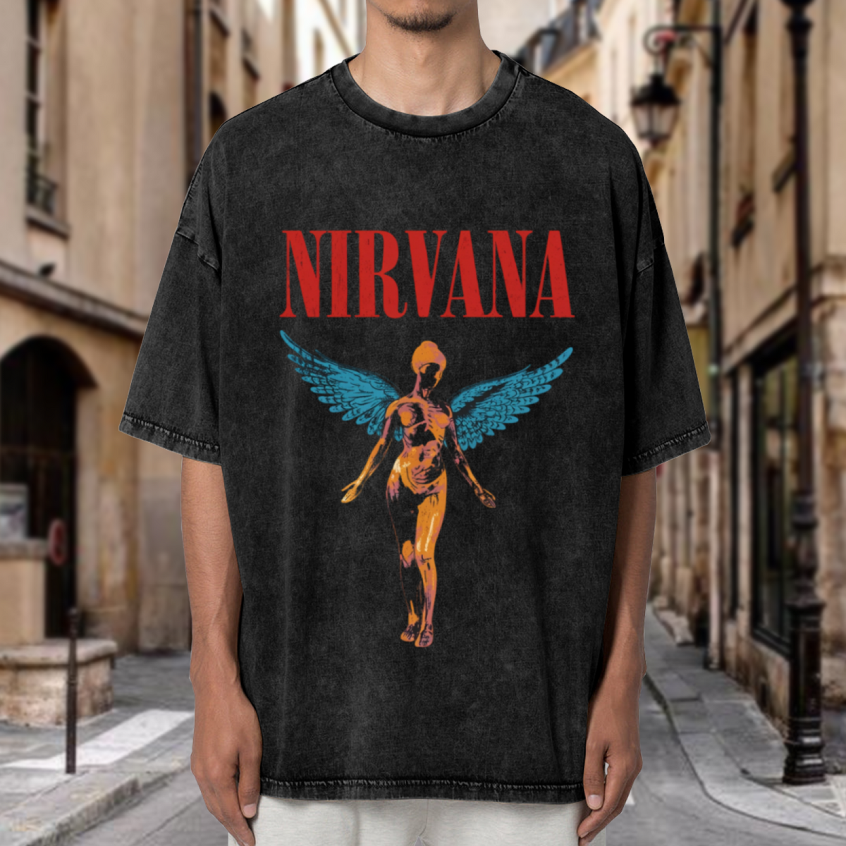 Nirvana In Utero Winged Angel Washed Tee in Black, product image showing an In Utero-themed winged angel graphic with red lettering and blue wing details.