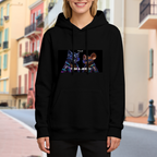 A cartoon cat and mouse against a neon-toned backdrop visible on a women's hoodie in an outdoor front model view