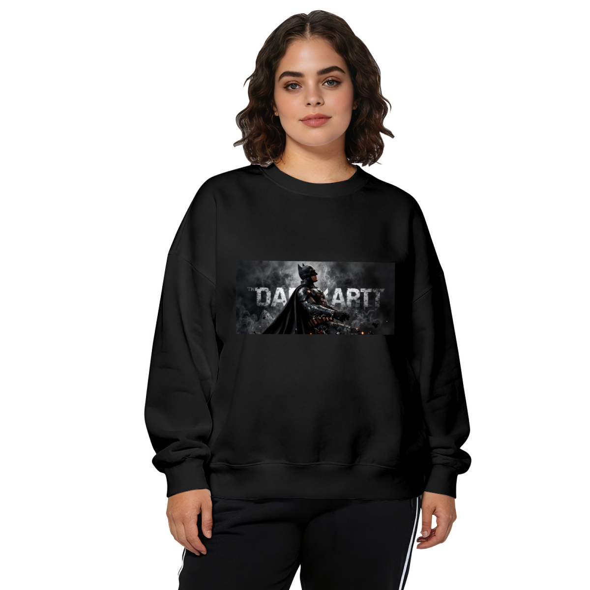 Studio photograph of a model in a women's crewneck sweatshirt showing an armored figure in a smoky grayscale panel with lettering