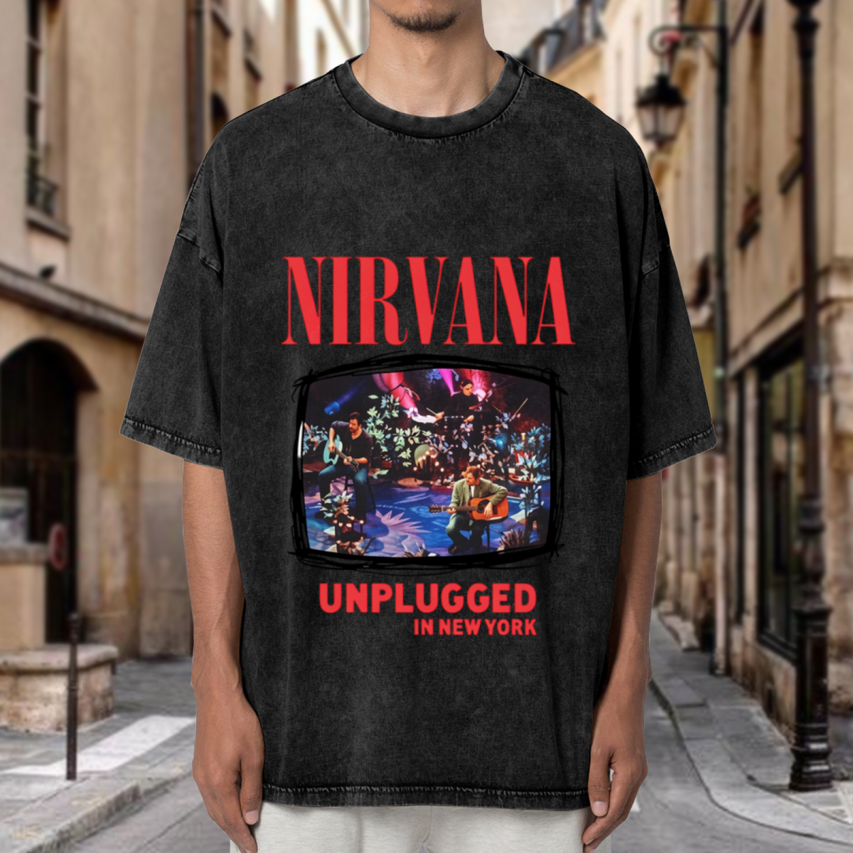 Nirvana MTV Unplugged New York Washed Tee in Black, product image showing nirvana’s MTV Unplugged in New York stage photograph framed by album-inspired lettering.