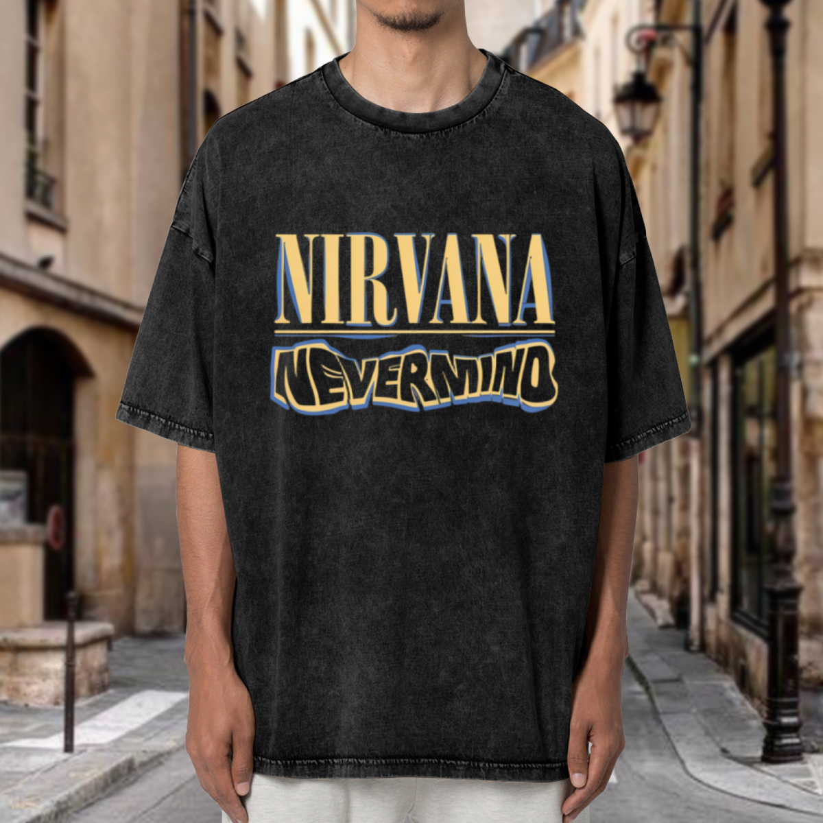 Nirvana Nevermind Logo Washed Graphic Tee in Black, product image showing a Nevermind-themed lettering graphic using yellow and blue tones.