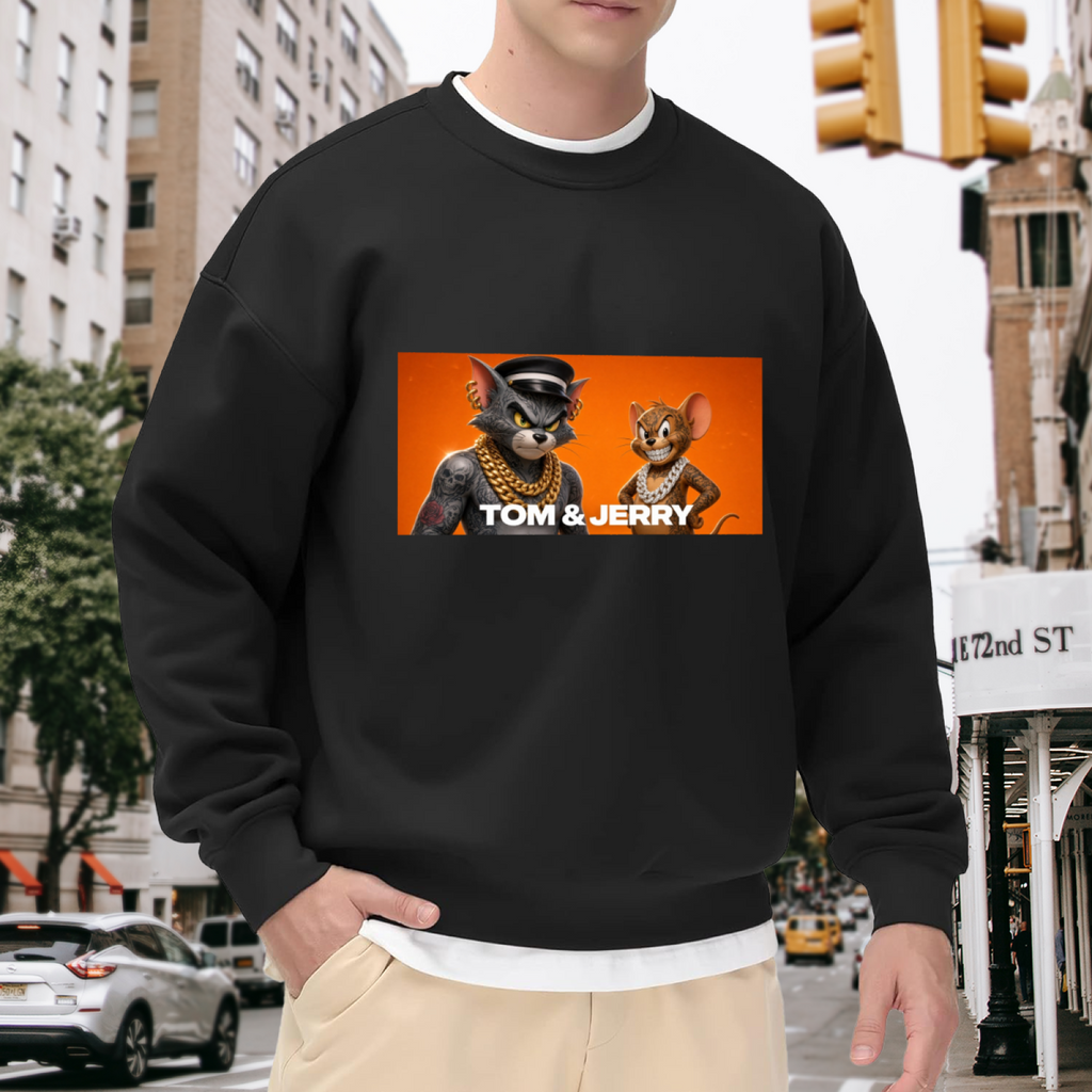 Outdoor photograph of a model in a men's crewneck sweatshirt bearing a cartoon cat and mouse wearing gold chains in a portrait panel