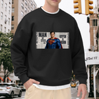 Men's crewneck sweatshirt worn outside, with the camera facing the graphic of a classic caped figure posed against a rectangular newspaper-style collage