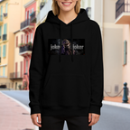 Lifestyle image outdoors: women's hoodie with a front graphic of a laughing suited figure in a horizontal lettered panel