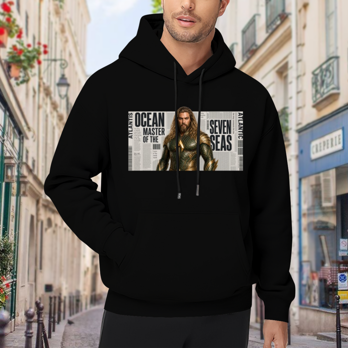 Lifestyle image outdoors: men's hoodie with a front graphic of a long-haired ocean warrior in armor against newspaper-style lettering