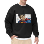Front-facing model wearing a men's crewneck sweatshirt decorated with a tightly cropped intense face above a cape against newsprint