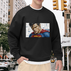 Outdoor photograph of a model in a men's crewneck sweatshirt bearing a tightly cropped intense face above a cape against newsprint