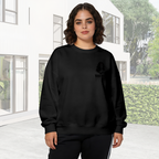 Outdoor photograph of a model in a women's crewneck sweatshirt bearing a compact warrior silhouette in an ink-like style with lettering