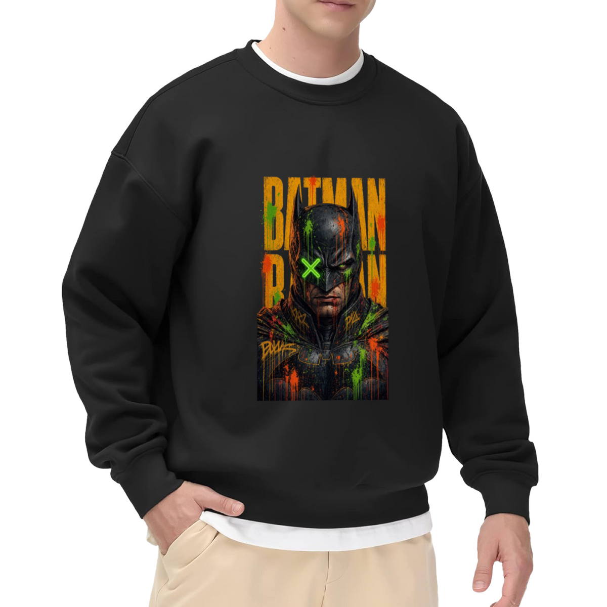 On-model product photo: men's crewneck sweatshirt bearing a tall graffiti-style cowl portrait with a green X across the eyes