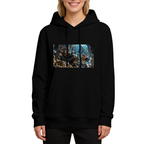 On-model product photo: women's hoodie bearing a feline court in an icy throne hall with elaborate frozen architecture