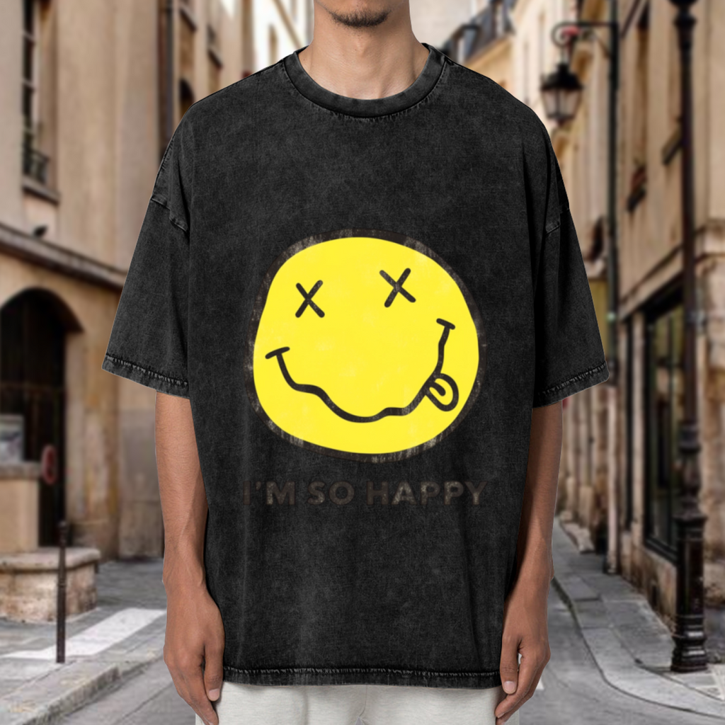 Nirvana Smiley Face Yellow Washed Tee in Black, product image showing a yellow smiley-face print associated with Nirvana and the words I’m So Happy.