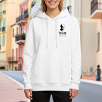 Lifestyle image outdoors: women's hoodie with a front graphic of a small masked silhouette with lightning-themed ink lettering