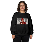 Women's crewneck sweatshirt seen on a model, its front graphic depicting a scarlet-cowl portrait against a rectangular newspaper-style backdrop