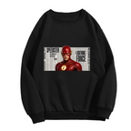 Front garment photograph: women's crewneck sweatshirt decorated with a scarlet-cowl portrait against a rectangular newspaper-style backdrop