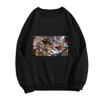 Front garment photograph: women's crewneck sweatshirt decorated with a trident-bearing cat surrounded by surging waves in a sea battle