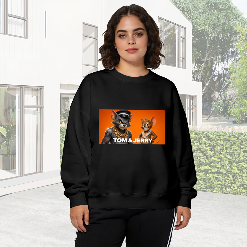 A cartoon cat and mouse wearing gold chains in a portrait panel visible on a women's crewneck sweatshirt in an outdoor front model view