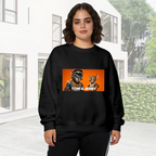 A cartoon cat and mouse wearing gold chains in a portrait panel visible on a women's crewneck sweatshirt in an outdoor front model view