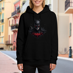 On-location model photograph displaying a pointed-cowl portrait above a crimson crest on the front of a women's hoodie